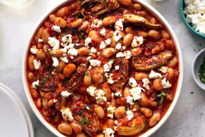 Thumbnail for Saucy Beans and Artichoke Hearts With Feta